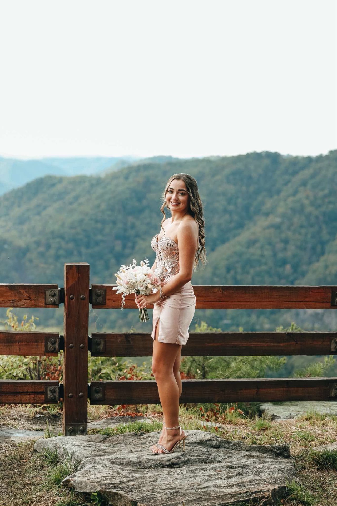 Homecoming dress in blush pink with beaded bodice on mountain overlook