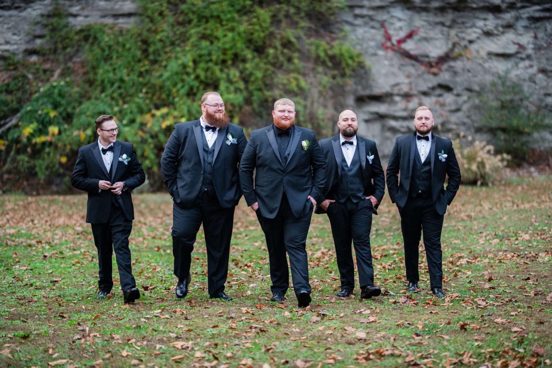 Groomsmen in black tuxedos with bow ties